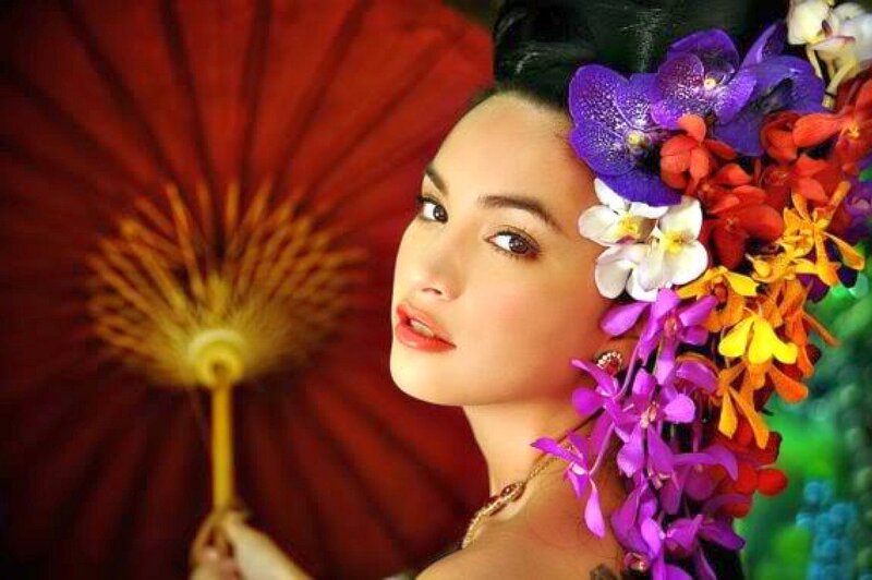 woman with floral crown and red fan