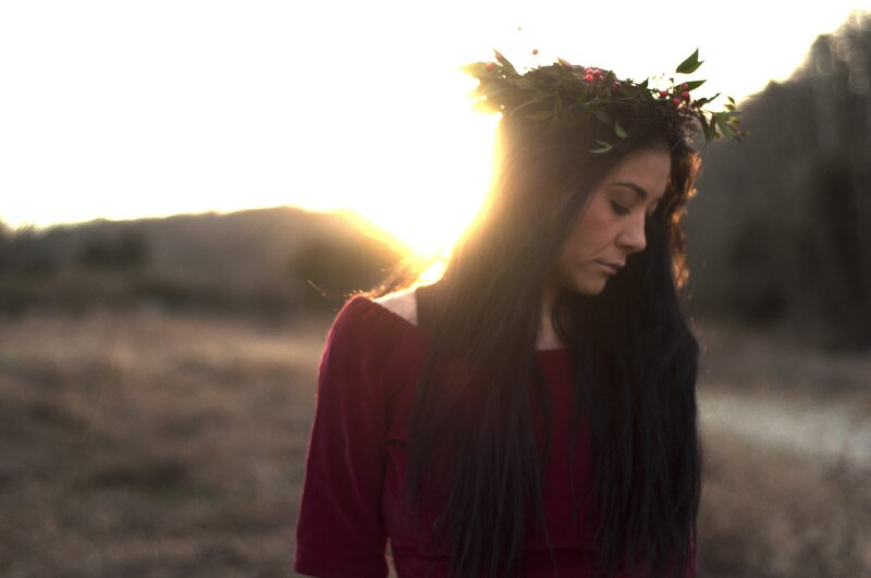 woman with floral crown at sunset