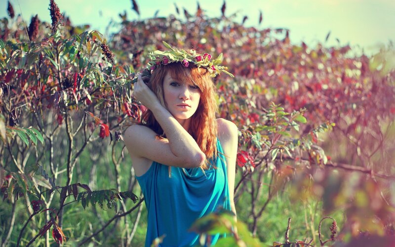 Woman with floral crown in field