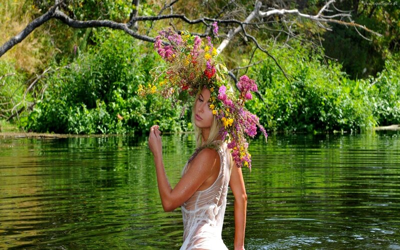 Woman with floral crown in river