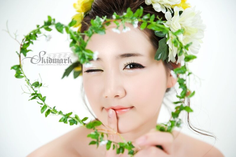 woman with floral crown winking