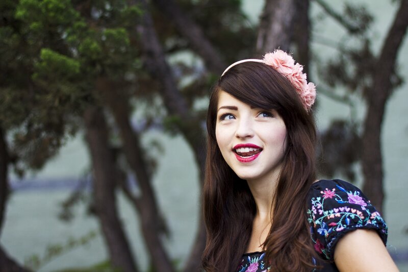 woman with floral headband smiling
