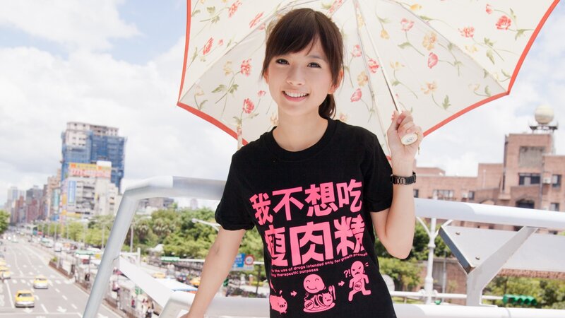 Woman with floral umbrella in city