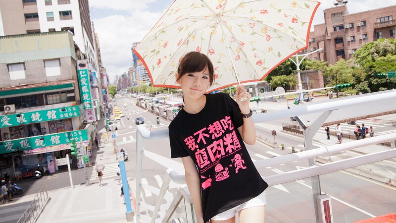 Woman with floral umbrella on bridge