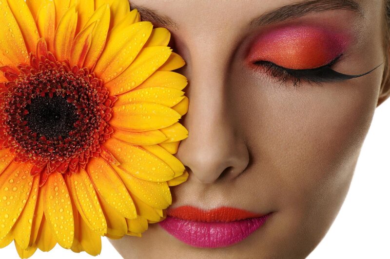 woman with flower and colorful makeup