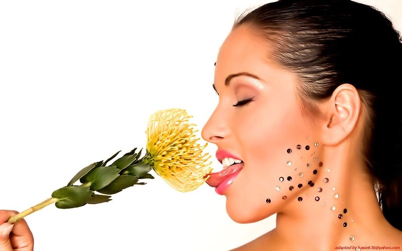 woman with flower and face gems