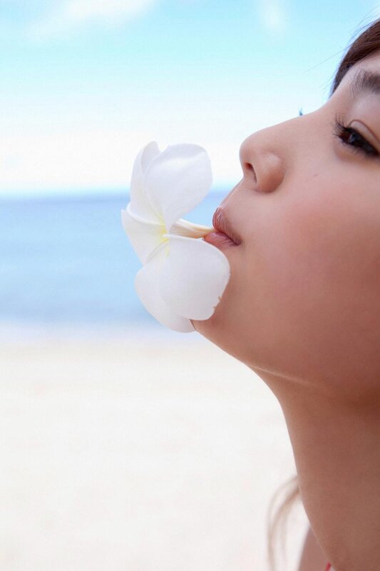 woman with flower at beach
