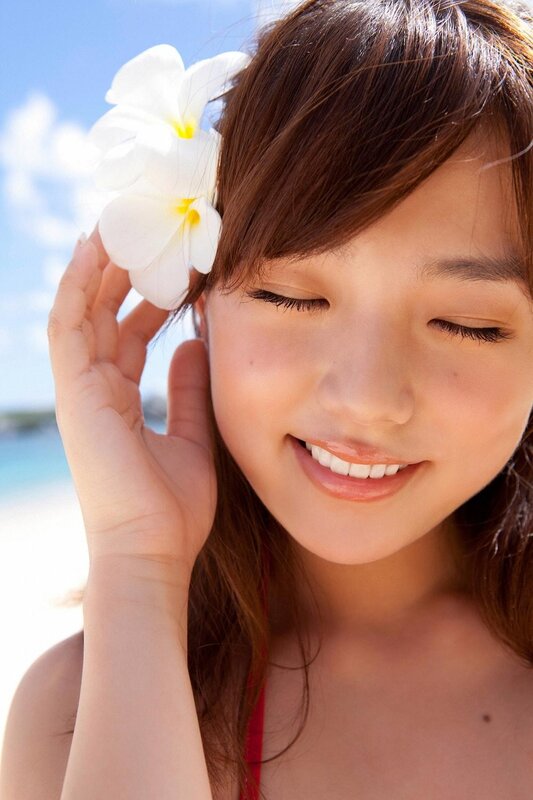 Woman with flower at beach