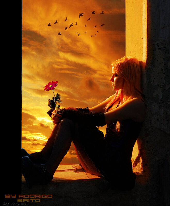 woman with flower at sunset