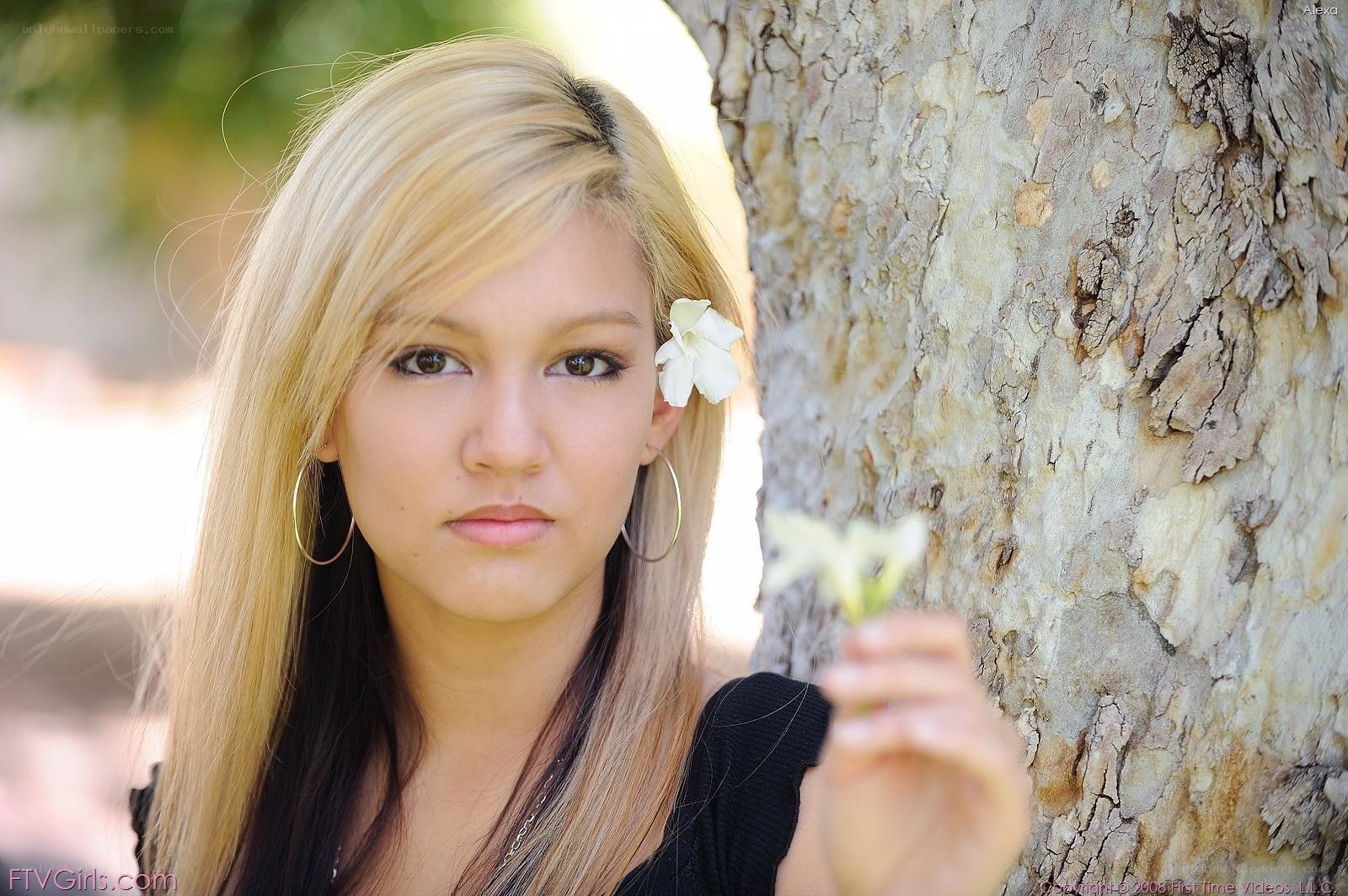 woman with flower by tree