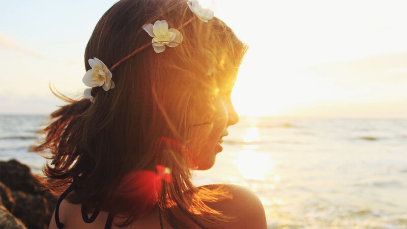 woman with flower crown at sunset