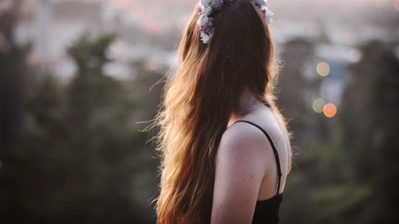 woman with flower crown at sunset