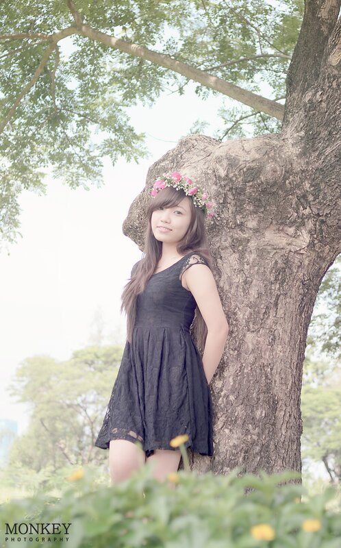 woman with flower crown by tree
