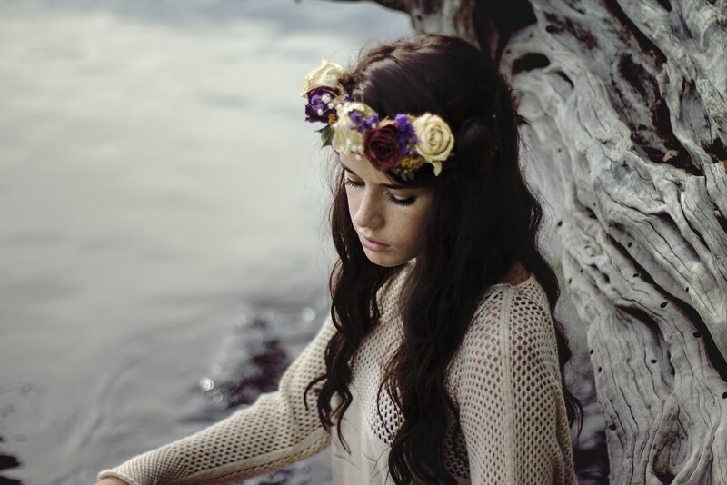 woman with flower crown by water