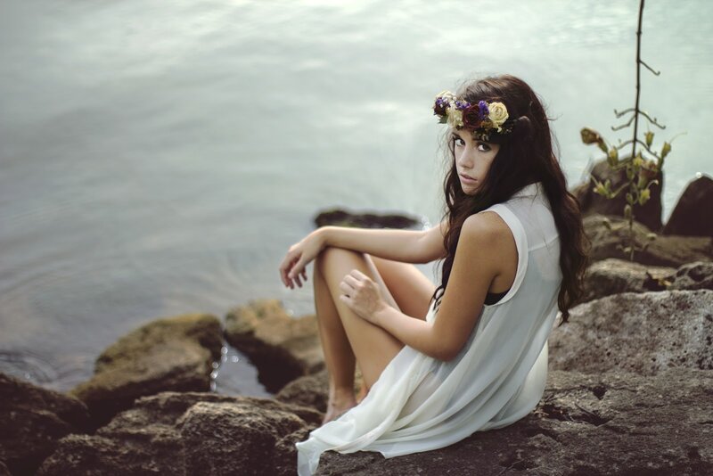 woman with flower crown by water