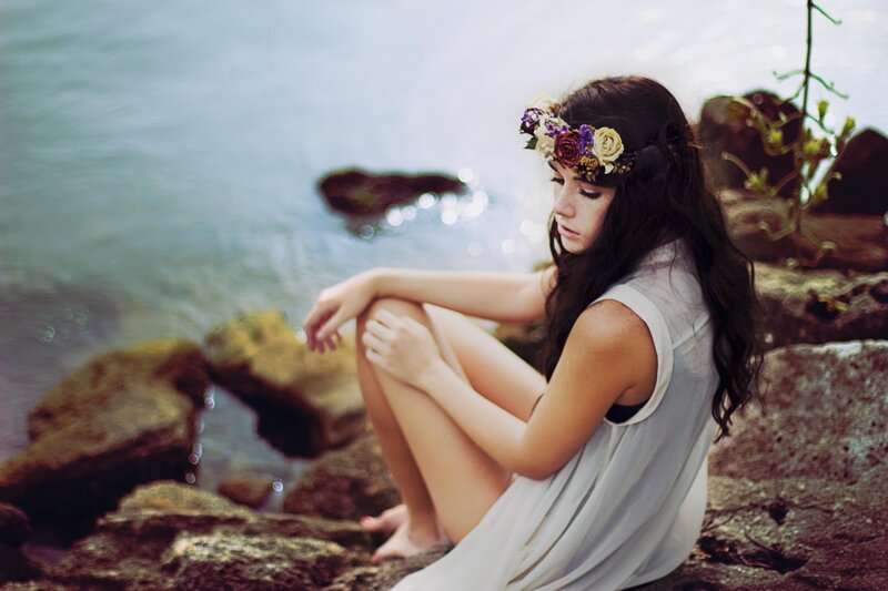 woman with flower crown by water
