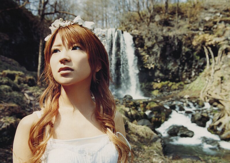 Woman with flower crown by waterfall