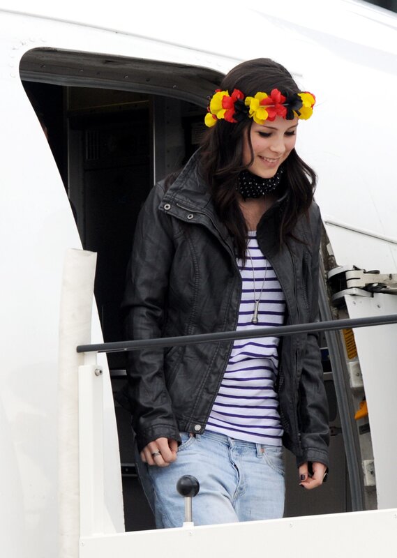 woman with flower crown exiting plane