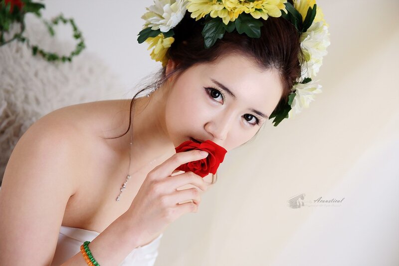 woman with flower crown holding rose