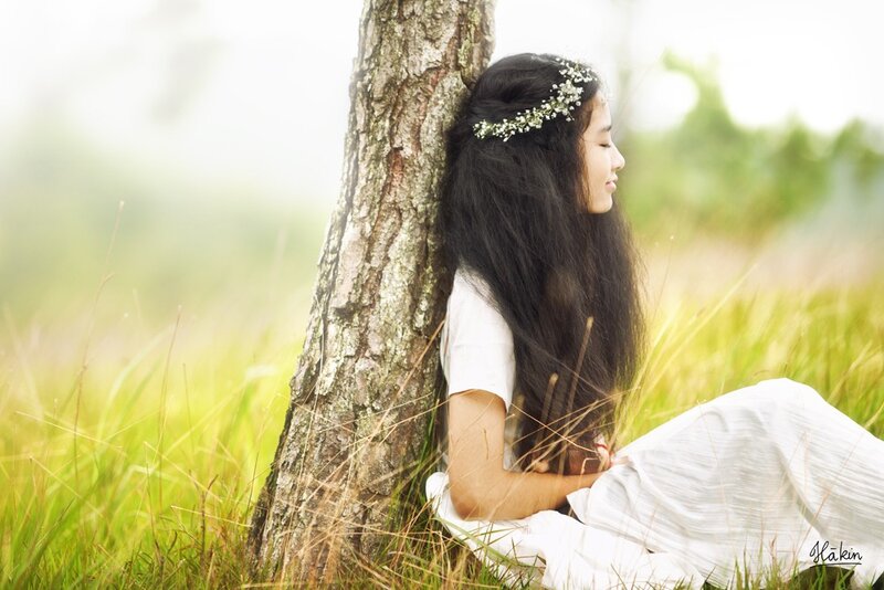 woman with flower crown in field