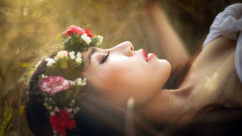 woman with flower crown in field