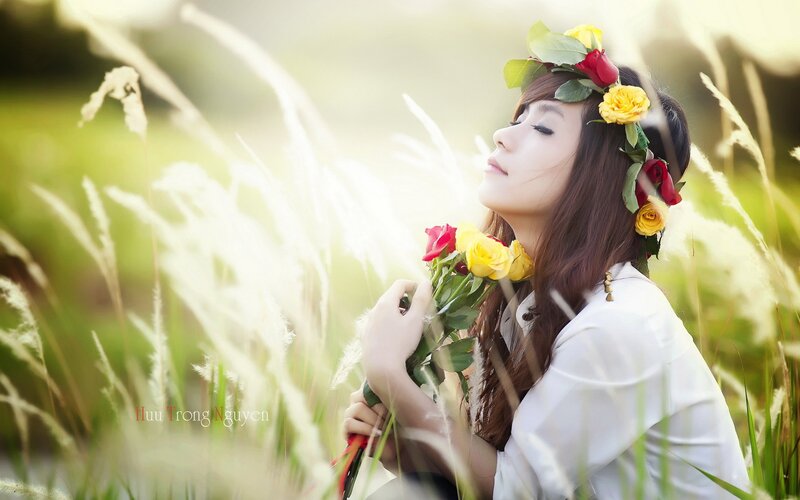 woman with flower crown in field