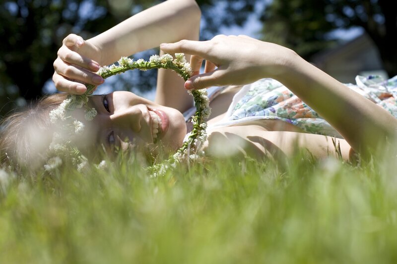 Woman with flower crown in grass