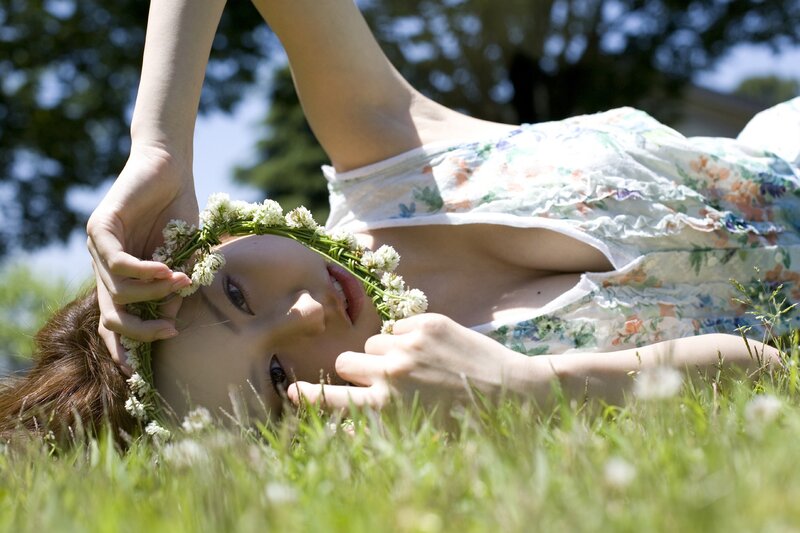 Woman with flower crown in grass