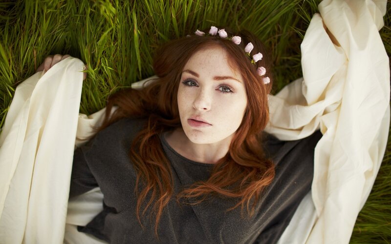 woman with flower crown in grass