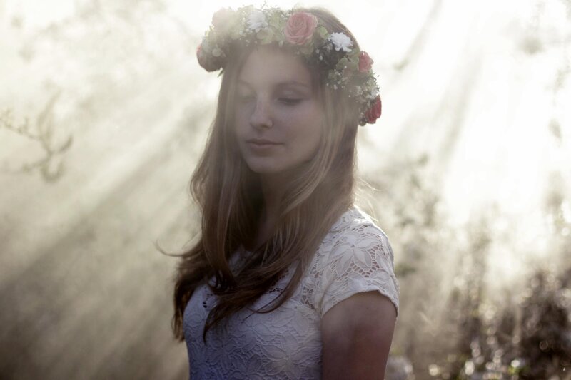 woman with flower crown in sunlight