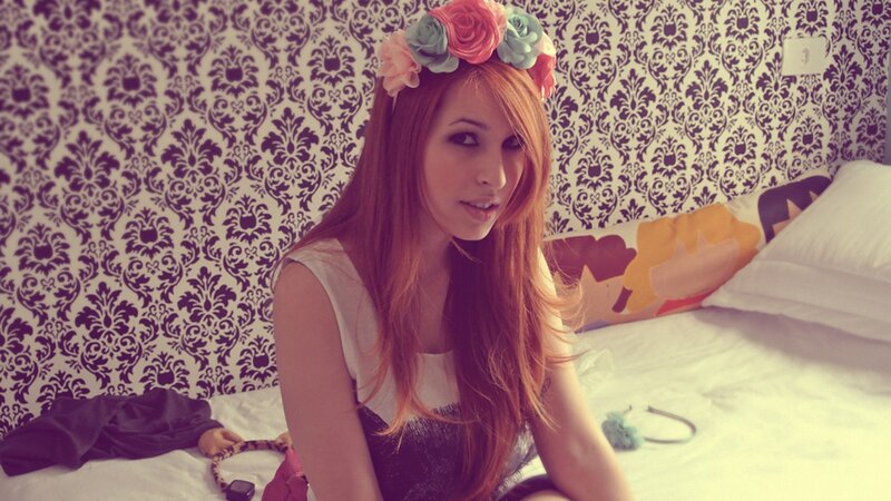 woman with flower crown on bed