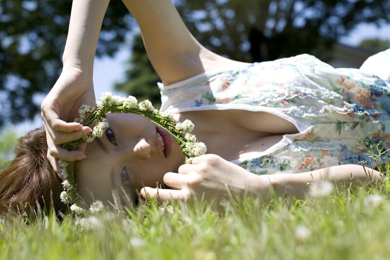 Woman with flower crown on grass