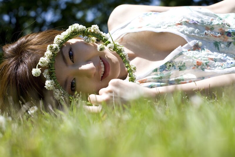 Woman with flower crown on grass