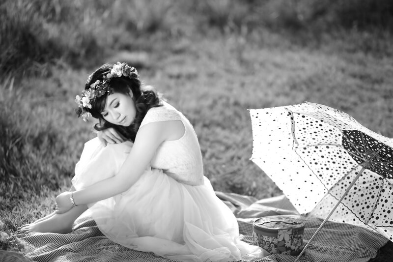 woman with flower crown sitting on blanket
