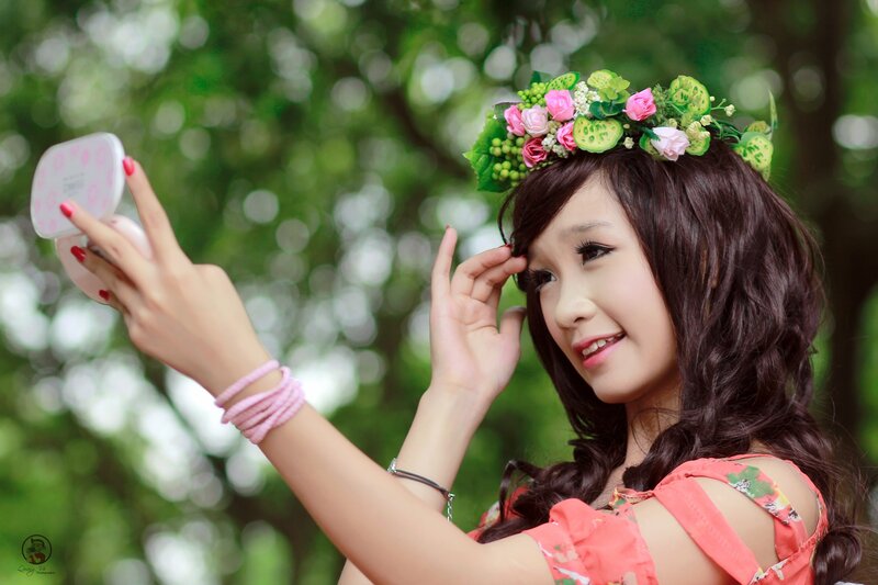 woman with flower crown taking selfie
