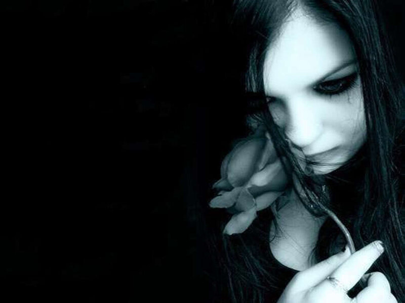 woman with flower in dark setting