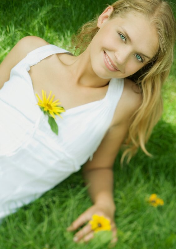 Woman with flower in grass