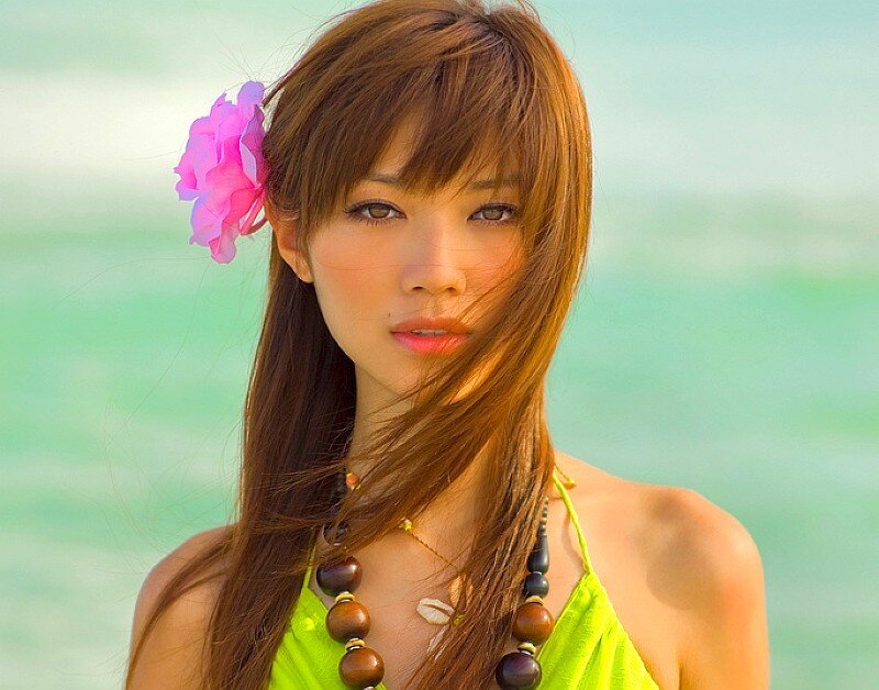 woman with flower in hair at beach