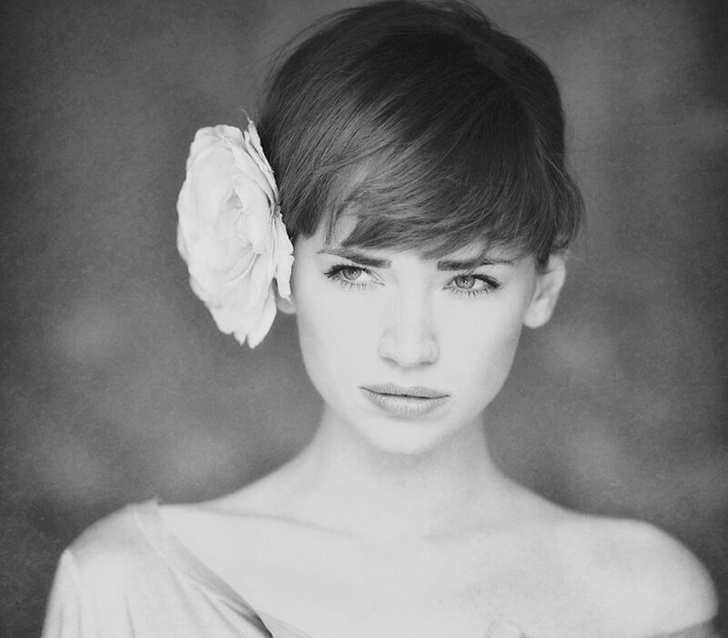 Woman with Flower in Hair — Black, Serious, Photograph