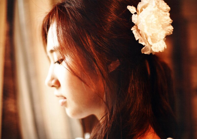 Woman with Flower in Hair — Brown, Serene, Sunset