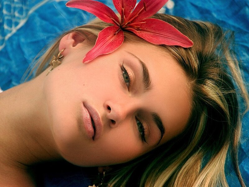 Woman with Flower in Hair — Red, Serene, Photograph, Earring, Blue Fabric
