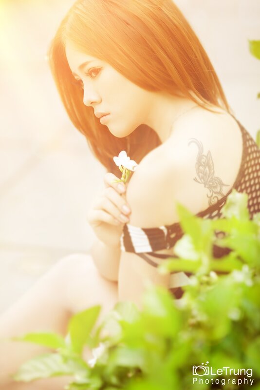 woman with flower in sunlight