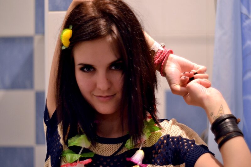 woman with flower lei in bathroom
