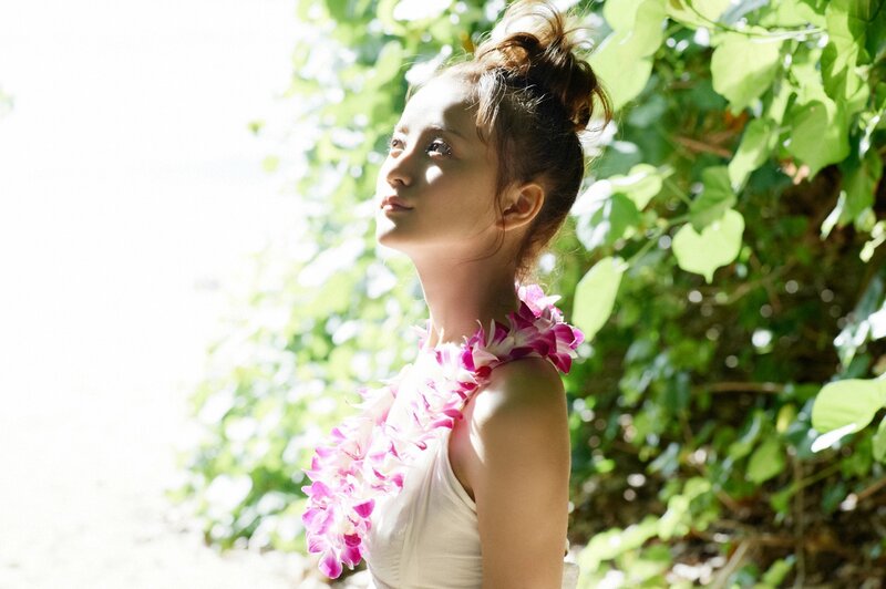 woman with flower lei in sunlight