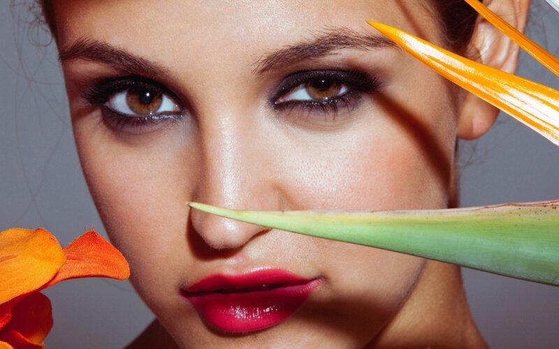woman with flower near face