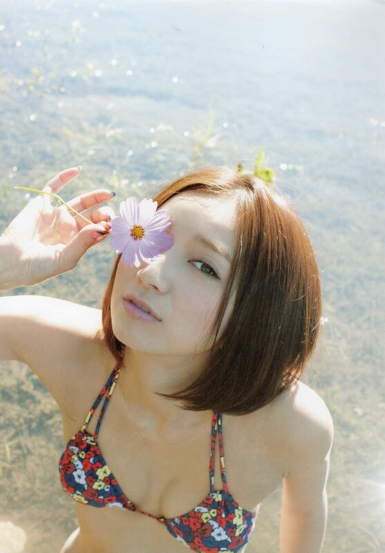woman with flower near water
