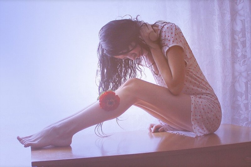 woman with flower on leg