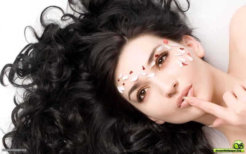 woman with flower petals on face