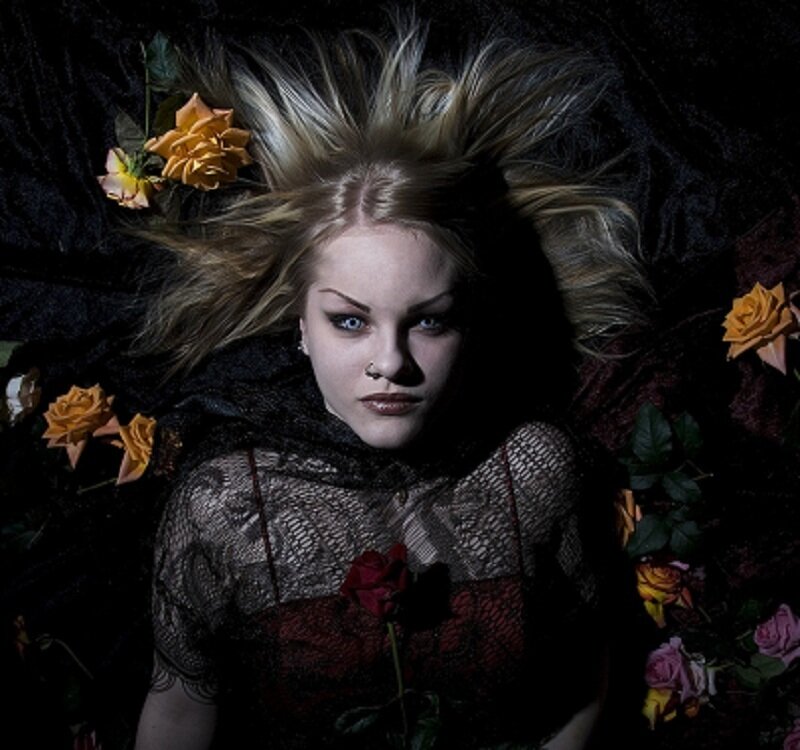 woman with flowers and dark makeup