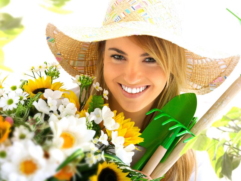 woman with flowers and gardening tools